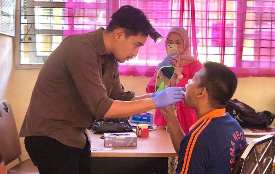drg. Muhammad Faishal memeriksa kondisi gigi dan rongga mulut siswa menggunakan bantuan visual. Dengan teknologi kamera intraoral, siswa dapat melihat langsung kondisi plak atau karies awal pada gigi mereka melalui layar monitor, sehingga edukasi yang diberikan terasa lebih nyata dan berdampak signifikan terhadap kesadaran perawatan gigi.